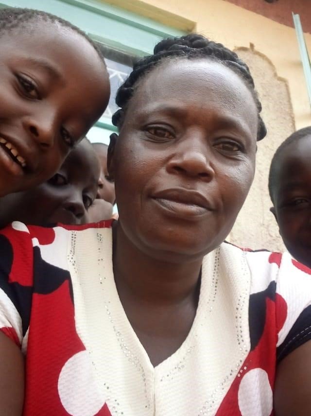 Phinora Analo, founder of Grace Calvary Ministries, with children in Kakamega